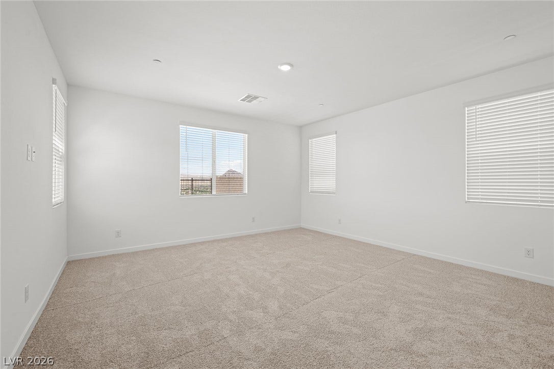 1480 Bianca Falls Drive, Henderson, NV 89011 Plush carpeting and multiple windows create a comfortable and inviting atmosphere.