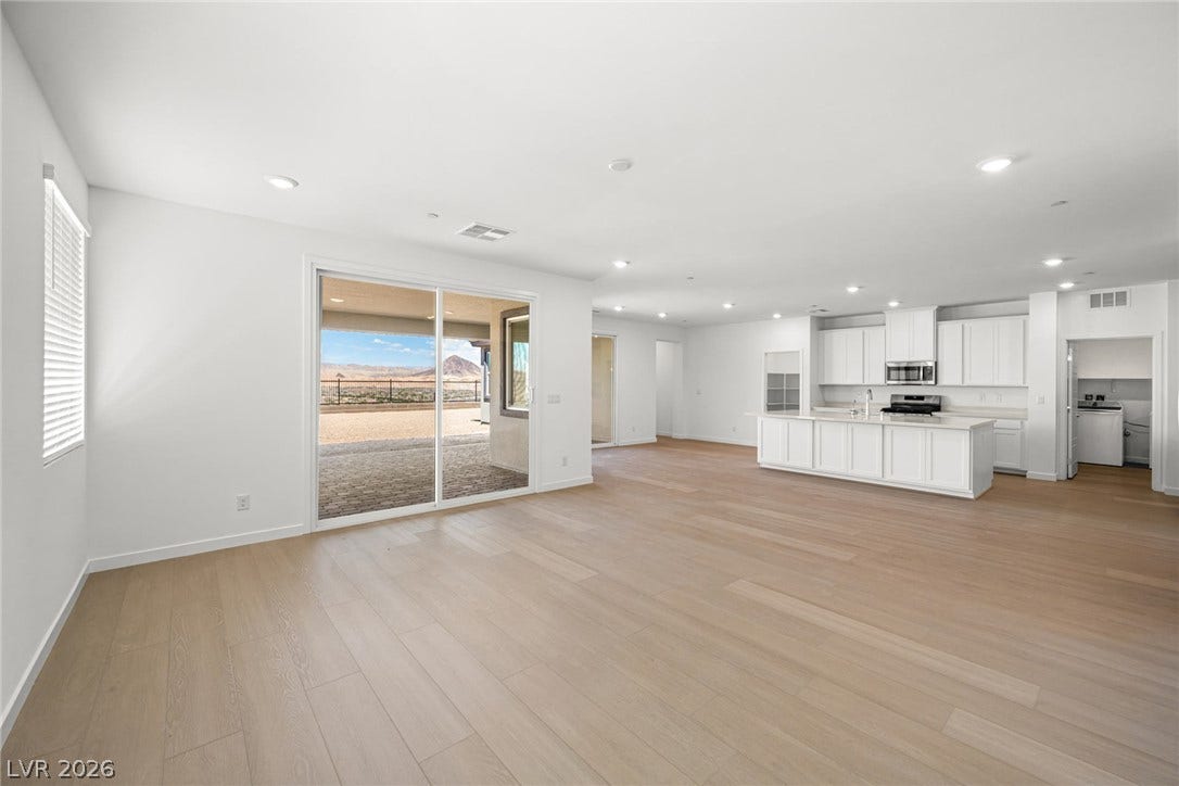 1480 Bianca Falls Drive, Henderson, NV 89011 Gleaming wood floors anchor this open concept layout connecting the main living area and kitchen.