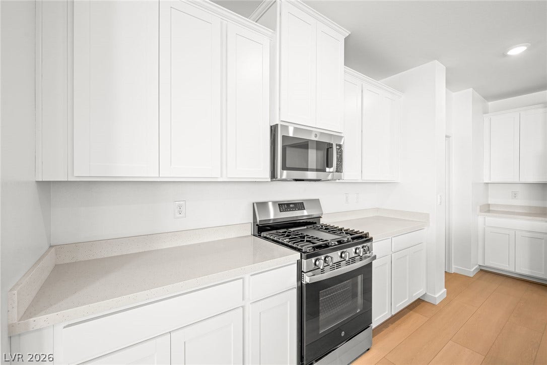 1480 Bianca Falls Drive, Henderson, NV 89011 Crisp cabinetry and clean stone countertops define this modern kitchen workspace.