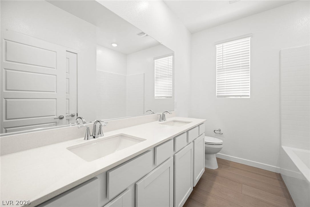 1480 Bianca Falls Drive, Henderson, NV 89011 A long double vanity with solid countertops anchors this modern bathroom.