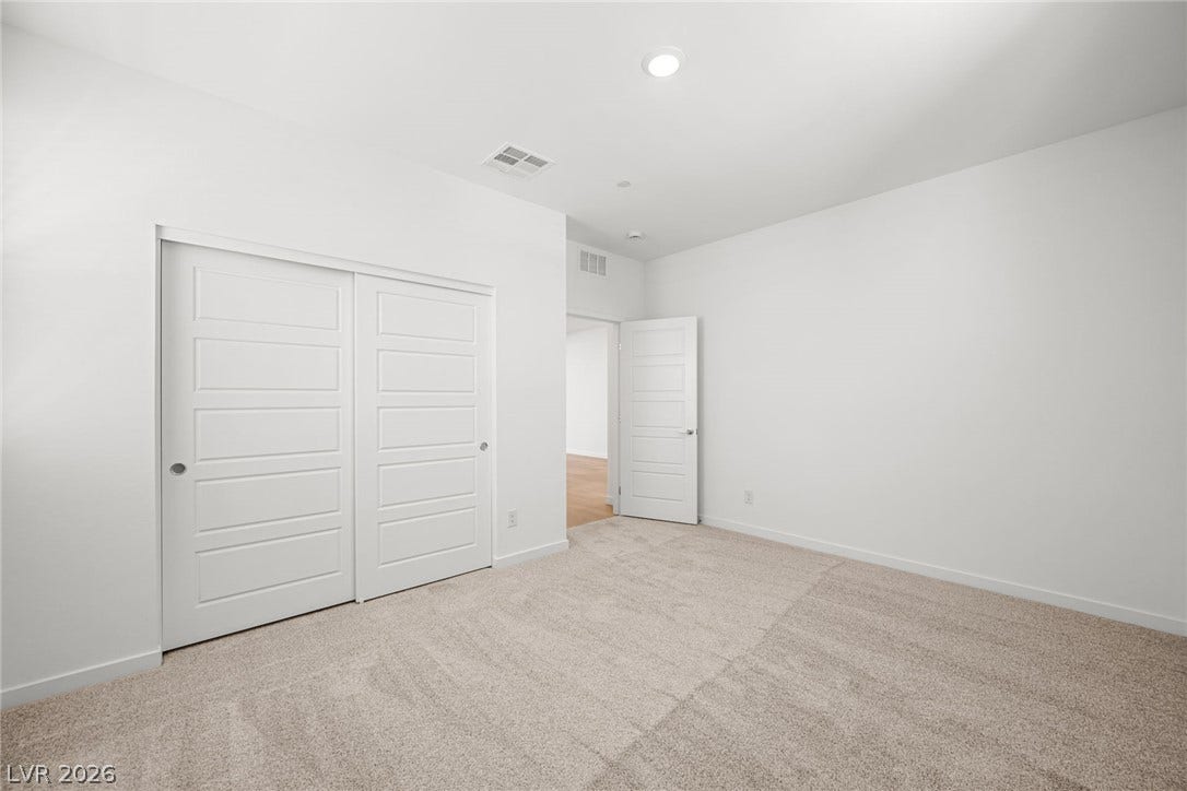 1480 Bianca Falls Drive, Henderson, NV 89011 Soft carpet underfoot pairs beautifully with clean white walls in this serene bedroom.
