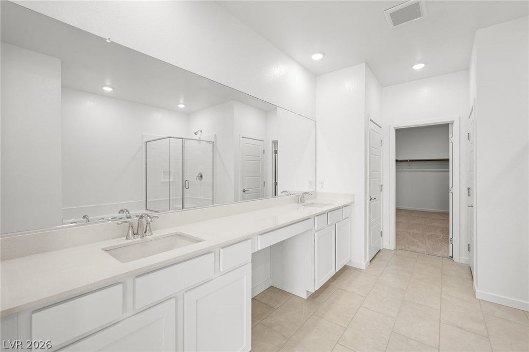 1480 Bianca Falls Drive, Henderson, NV 89011 A long dual vanity with stone countertops highlights this master bathroom.