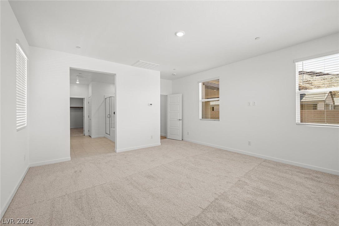 1480 Bianca Falls Drive, Henderson, NV 89011 Plush carpeting and recessed lighting define this comfortable bedroom suite with adjoining bath access.