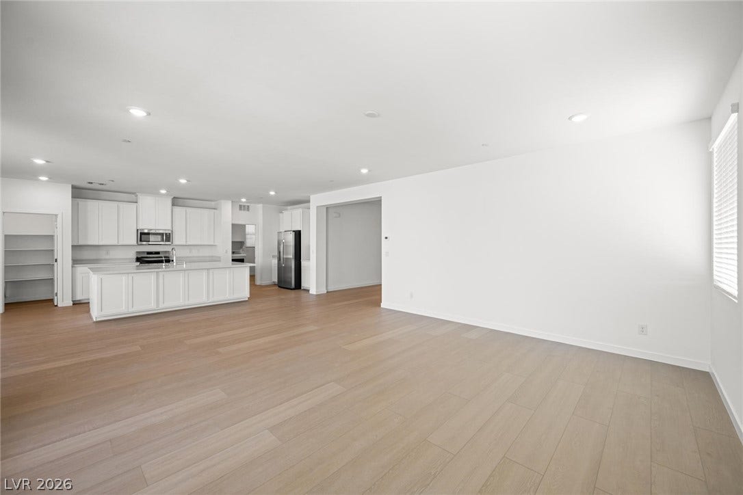 1480 Bianca Falls Drive, Henderson, NV 89011 Gleaming wood floors anchor this generous layout connecting the living area to a modern kitchen.