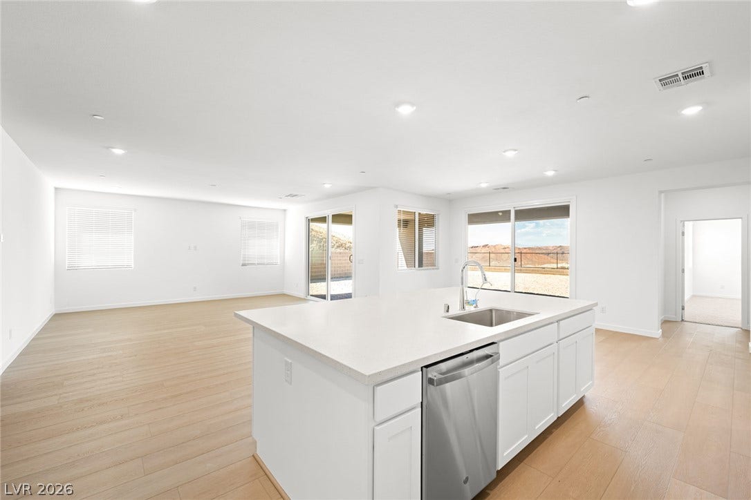 1480 Bianca Falls Drive, Henderson, NV 89011 Gleaming hardwood floors and a spacious island anchor this light-filled, open-concept living space.