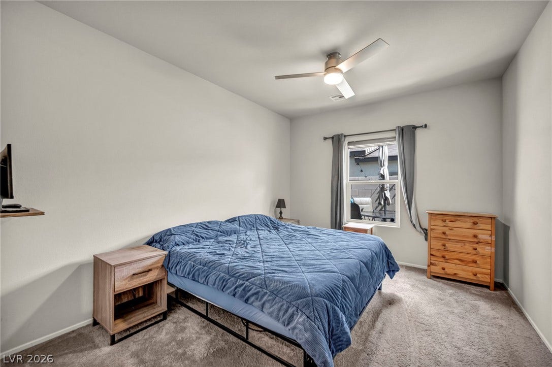 Plush carpeting and a large window facing the courtyard define this tranquil bedroom.