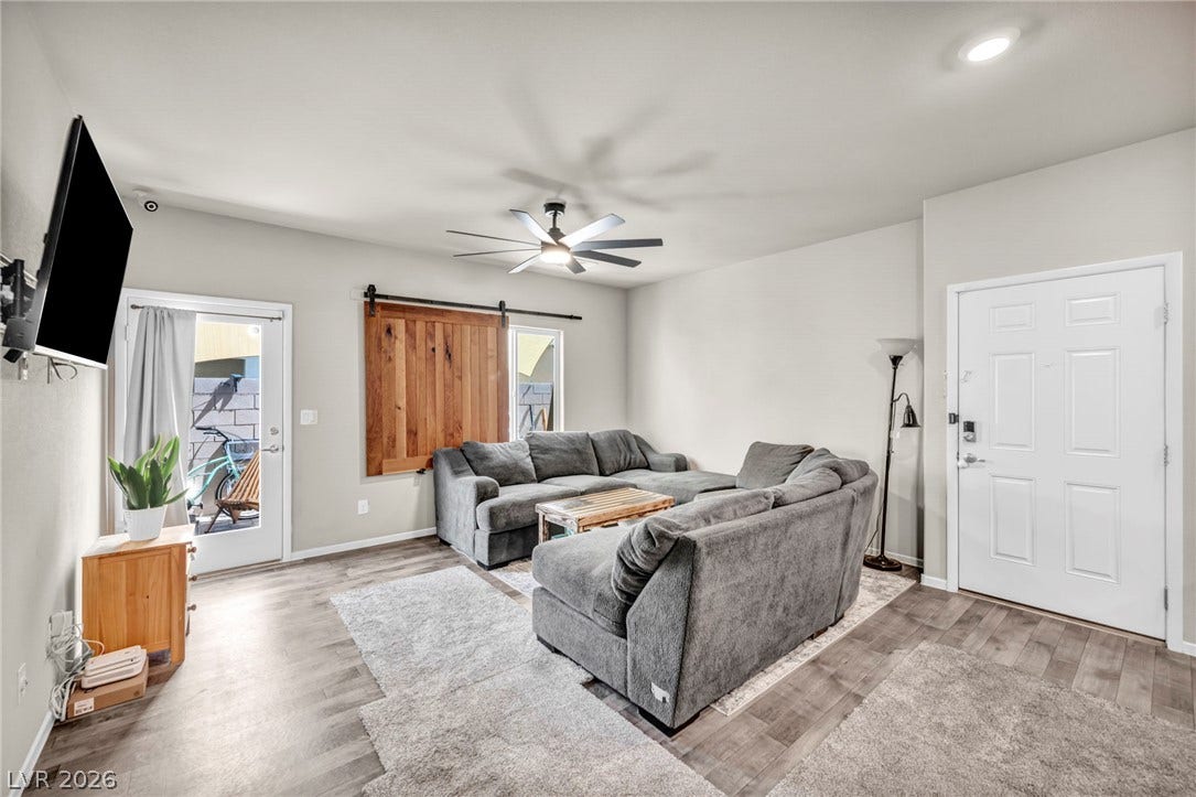 An inviting open entry leads into a comfortable living space with durable vinyl plank flooring.