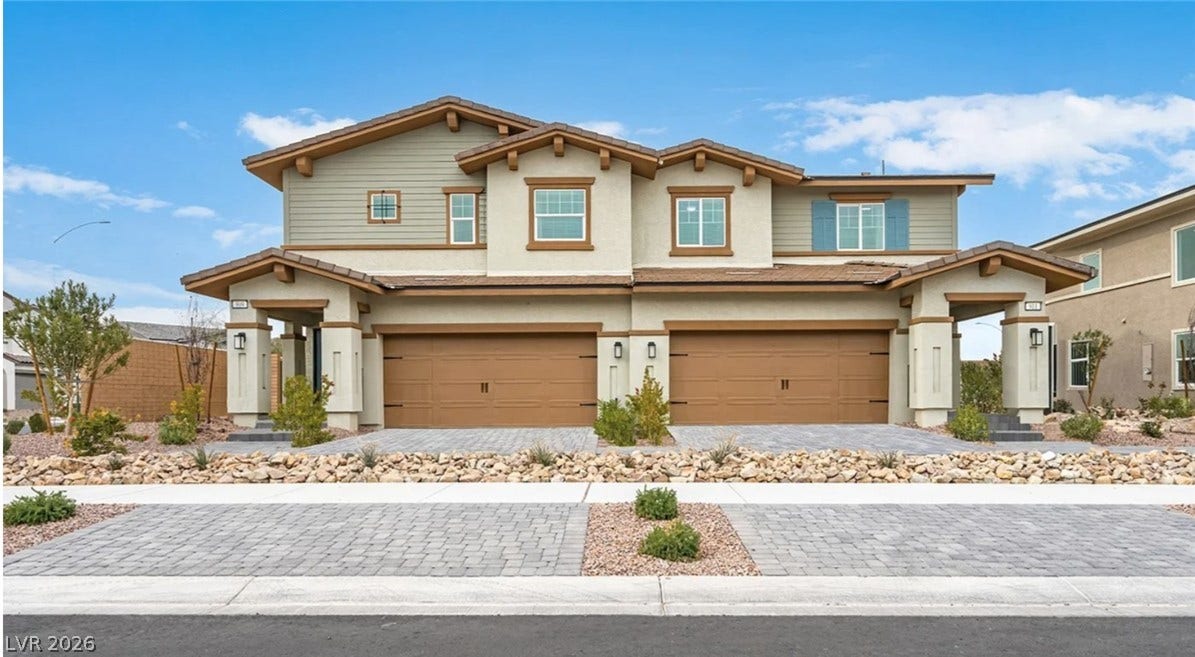 121 Scarhill Track Avenue, Henderson, NV 89011 A modern duplex exterior showcases stone pavers and a neutral color palette against blue skies.