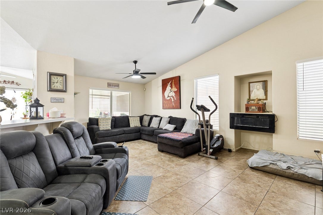 1747 Ashburn Drive, North Las Vegas, NV 89032 Vaulted ceilings and durable tile flooring highlight this airy living room space.