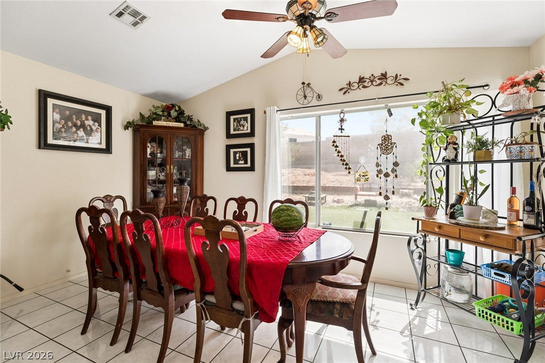 1747 Ashburn Drive, North Las Vegas, NV 89032 Tiled floors and vaulted ceilings elevate this comfortable dining area overlooking the yard.