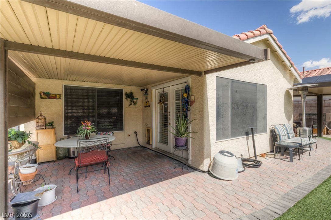 1747 Ashburn Drive, North Las Vegas, NV 89032 A spacious covered patio features durable paver flooring and seamless access to the indoors.