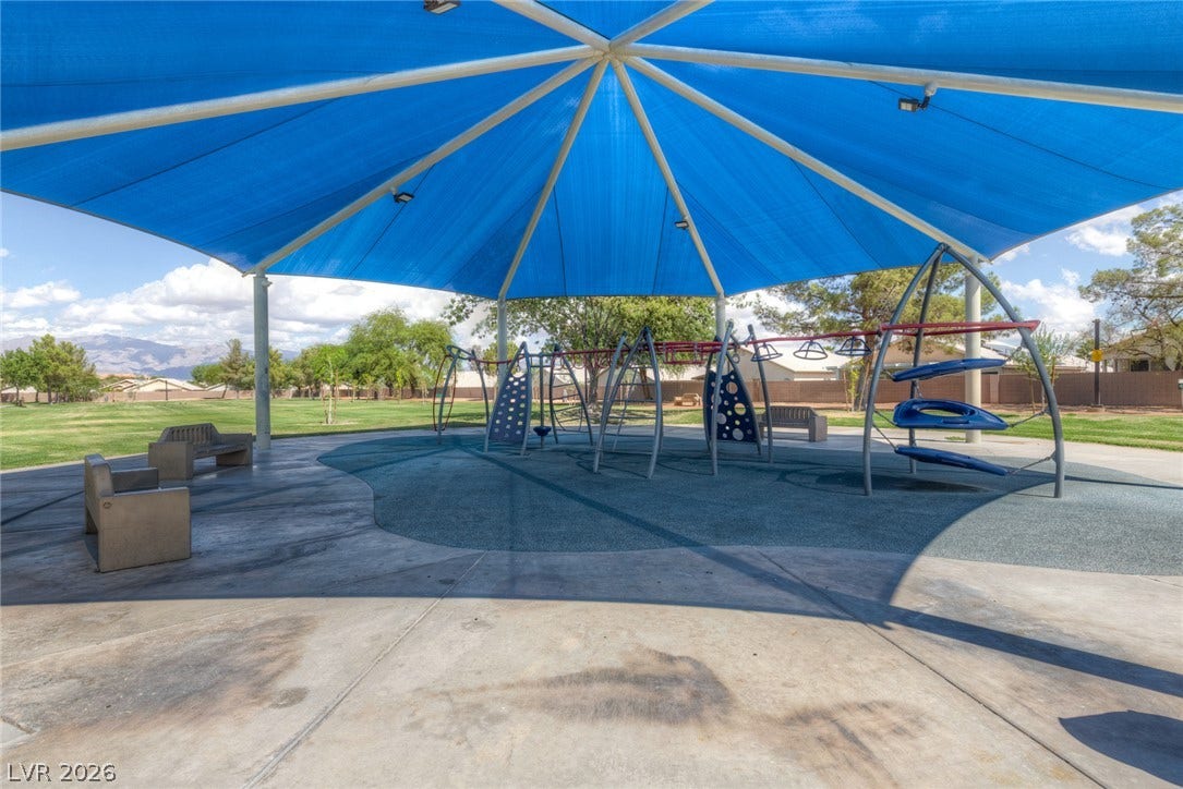 1747 Ashburn Drive, North Las Vegas, NV 89032 A spacious shaded play area sits adjacent to a grassy park with mountain views.