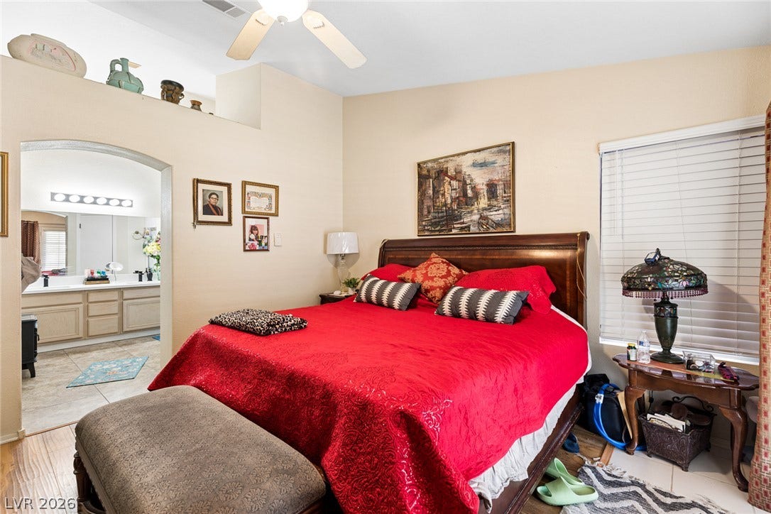 1747 Ashburn Drive, North Las Vegas, NV 89032 High ceilings and hard-surface flooring define this main bedroom with an adjoining bath.