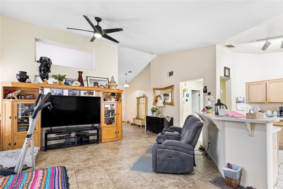 1747 Ashburn Drive, North Las Vegas, NV 89032 Vaulted ceilings and durable tile flooring highlight the airy, open-concept layout of this living space.