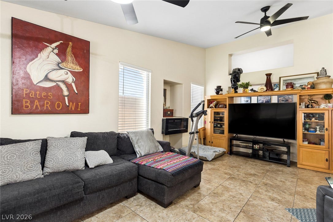 1747 Ashburn Drive, North Las Vegas, NV 89032 High ceilings and tile floors define this airy living space with tall windows.