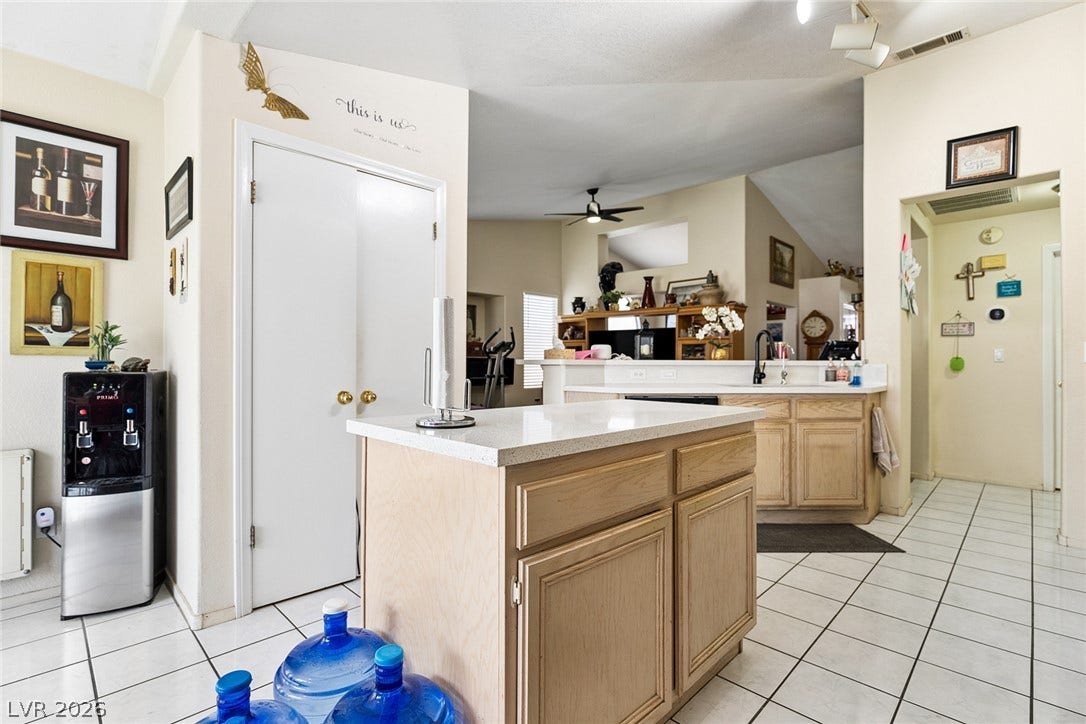 1747 Ashburn Drive, North Las Vegas, NV 89032 Tiled flooring and a central island define this functional culinary space.