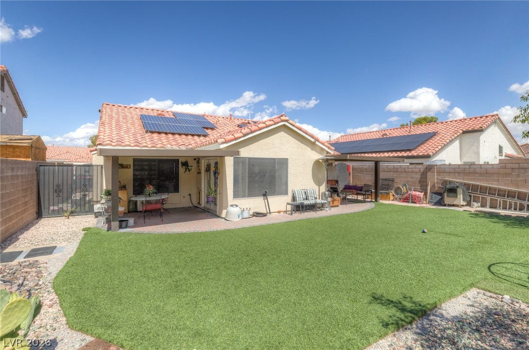 1747 Ashburn Drive, North Las Vegas, NV 89032 Spanish tile roofing and solar panels crown this single-story home overlooking a low-maintenance yard.