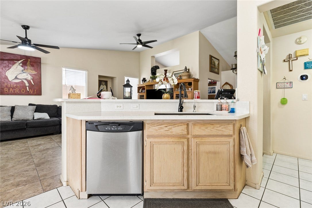 1747 Ashburn Drive, North Las Vegas, NV 89032 An open breakfast bar overlooks the adjoining living spaces under vaulted ceilings.