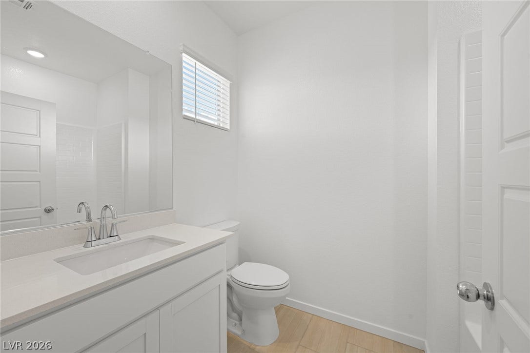8142 Gusty Brook Street, Las Vegas, NV 89113 Clean lines and stone counters highlight this modern bathroom space.