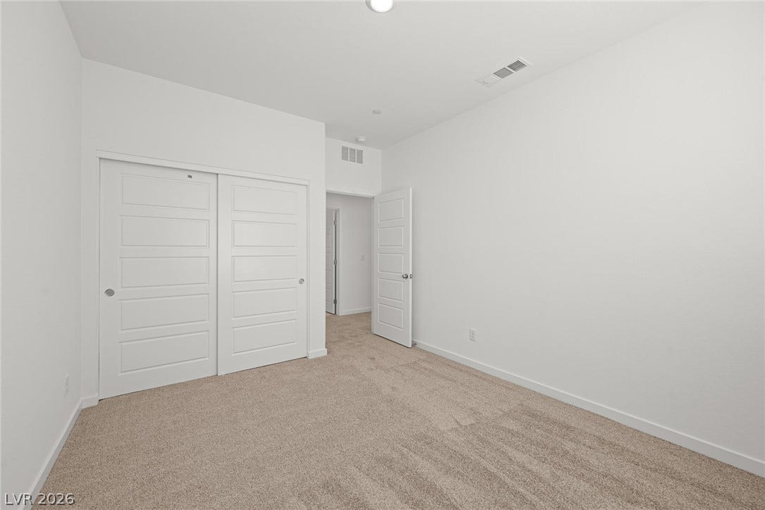8142 Gusty Brook Street, Las Vegas, NV 89113 Plush carpeting and crisp white trim enhance this quiet bedroom space.
