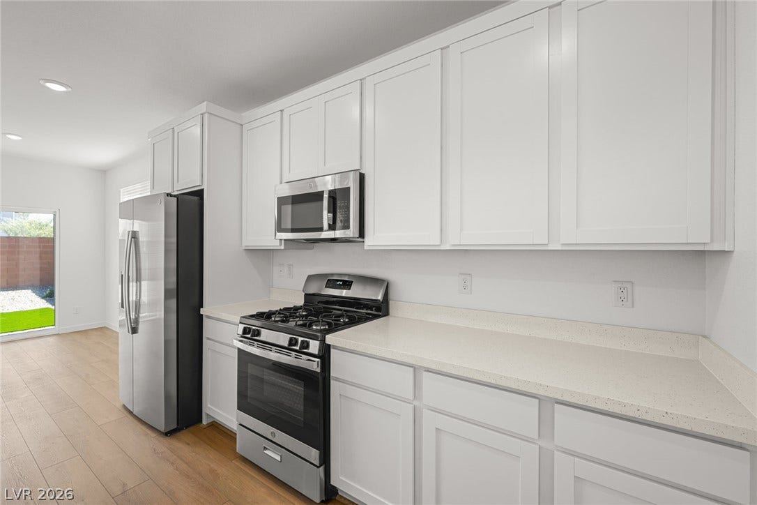 8142 Gusty Brook Street, Las Vegas, NV 89113 Streamlined cabinetry and sleek countertops frame a modern culinary workspace.