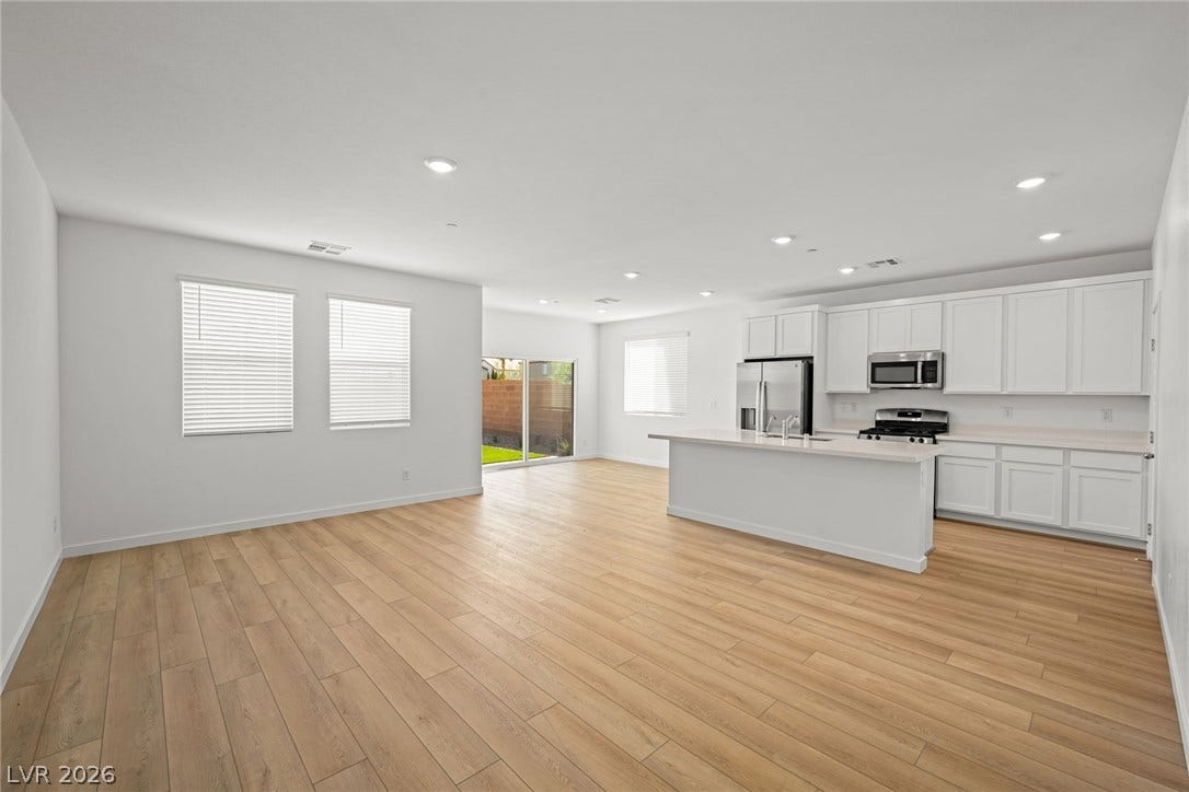 8142 Gusty Brook Street, Las Vegas, NV 89113 Clean lines and warm wood floors define this airy open-concept living area and kitchen.