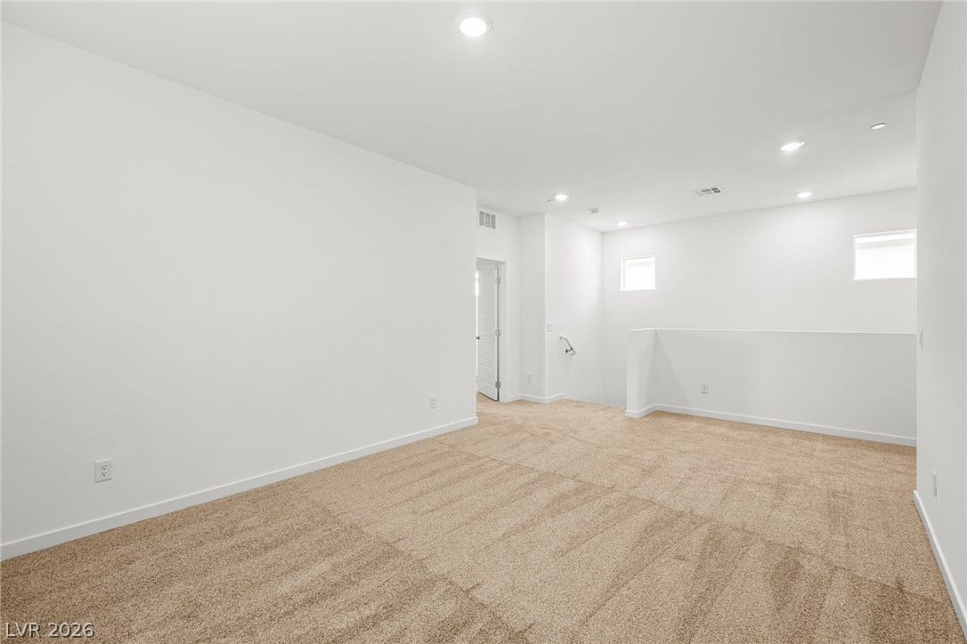 8142 Gusty Brook Street, Las Vegas, NV 89113 Recessed lighting and soft carpeting define this versatile upper-level loft space.