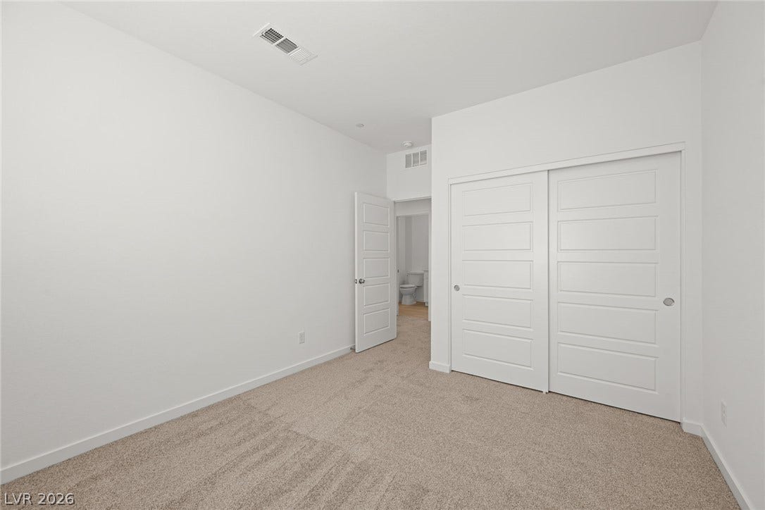 8142 Gusty Brook Street, Las Vegas, NV 89113 Smooth walls and neutral carpeting define this modern, comfortable bedroom space.