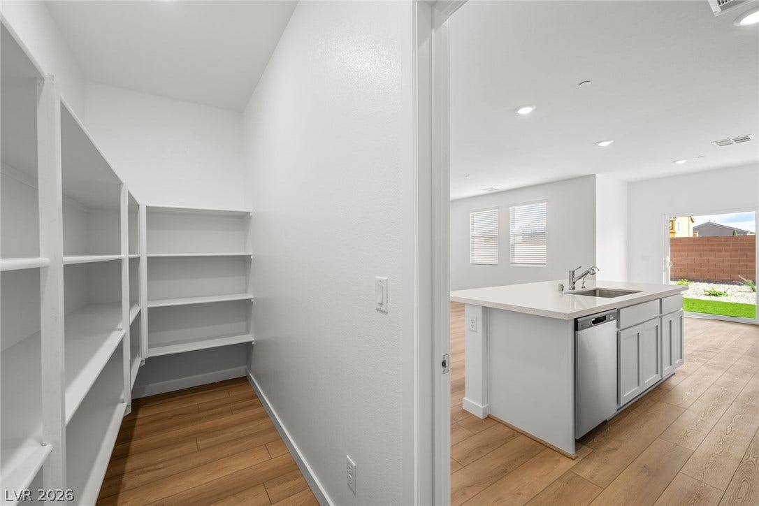 8142 Gusty Brook Street, Las Vegas, NV 89113 Ample built-in shelving maximizes storage potential in this walk-in kitchen pantry.