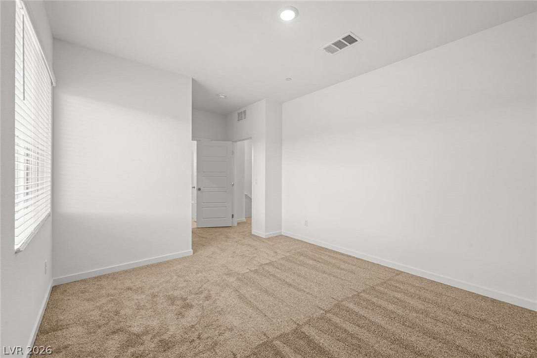8142 Gusty Brook Street, Las Vegas, NV 89113 Plush carpeting and recessed lighting create a comfortable atmosphere in this versatile bedroom.
