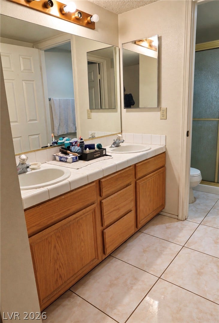 101 Luna Way, #242, Las Vegas, NV 89145 A spacious double vanity and tiled flooring anchor this functional bathroom.