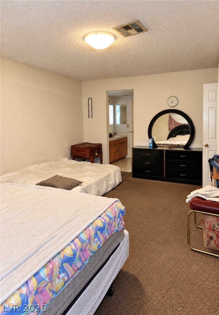 101 Luna Way, #242, Las Vegas, NV 89145 Plush wall-to-wall carpeting and neutral tones create a comfortable, quiet bedroom retreat.