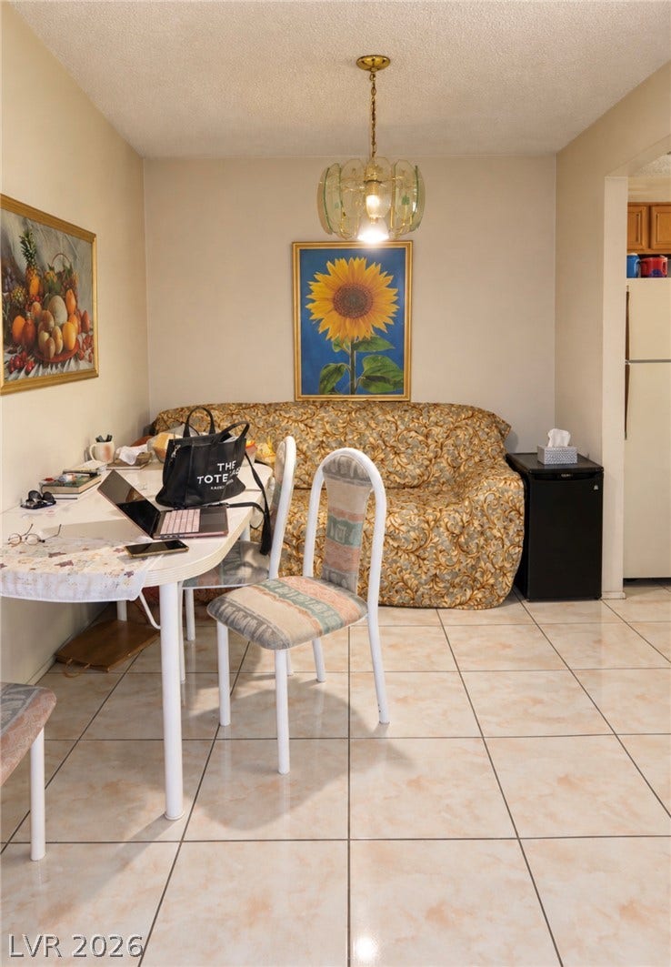 101 Luna Way, #242, Las Vegas, NV 89145 Tiled flooring and a classic light fixture define this versatile casual dining area.