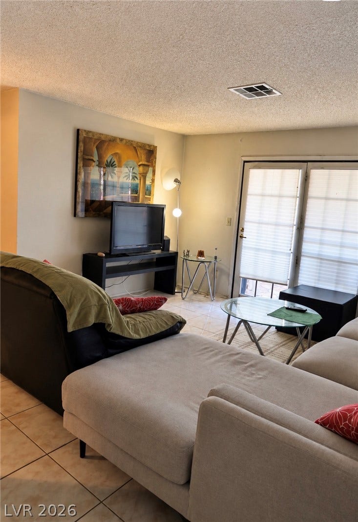 101 Luna Way, #242, Las Vegas, NV 89145 Tiled flooring and glass doors lead outdoors from this functional living space.