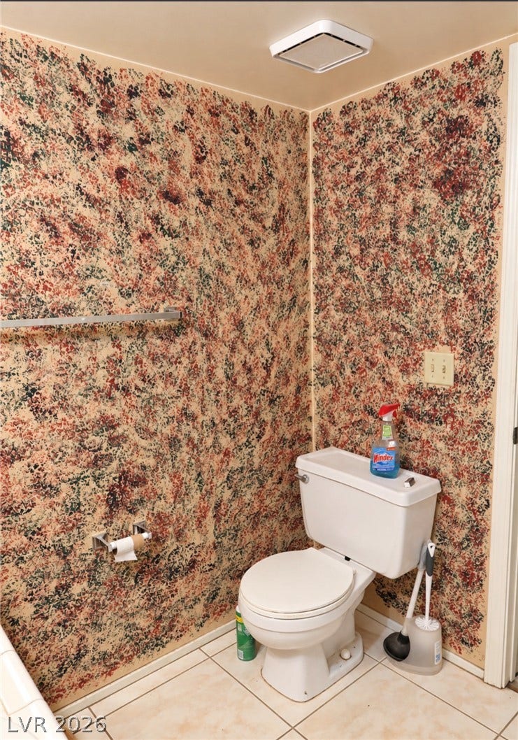 101 Luna Way, #242, Las Vegas, NV 89145 Tiled flooring and unique wall finishes define this functional powder room space.
