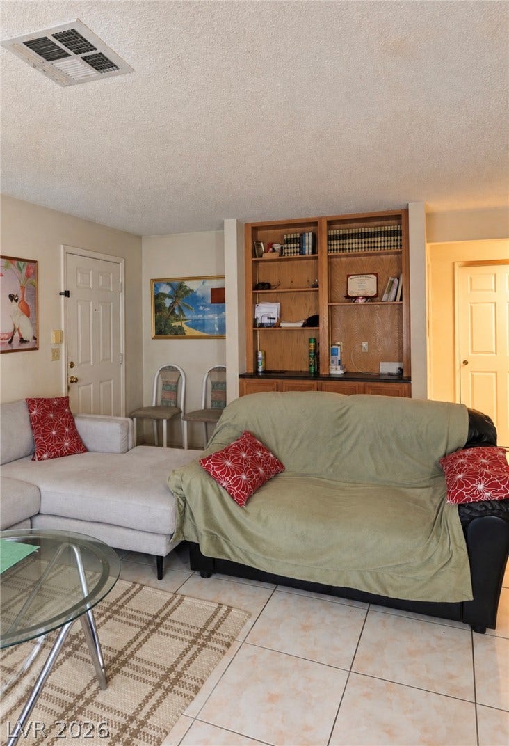 101 Luna Way, #242, Las Vegas, NV 89145 Tiled flooring and built-in shelving elements define this functional living area.