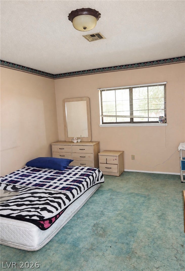 101 Luna Way, #242, Las Vegas, NV 89145 A single window provides natural light to this carpeted bedroom space.