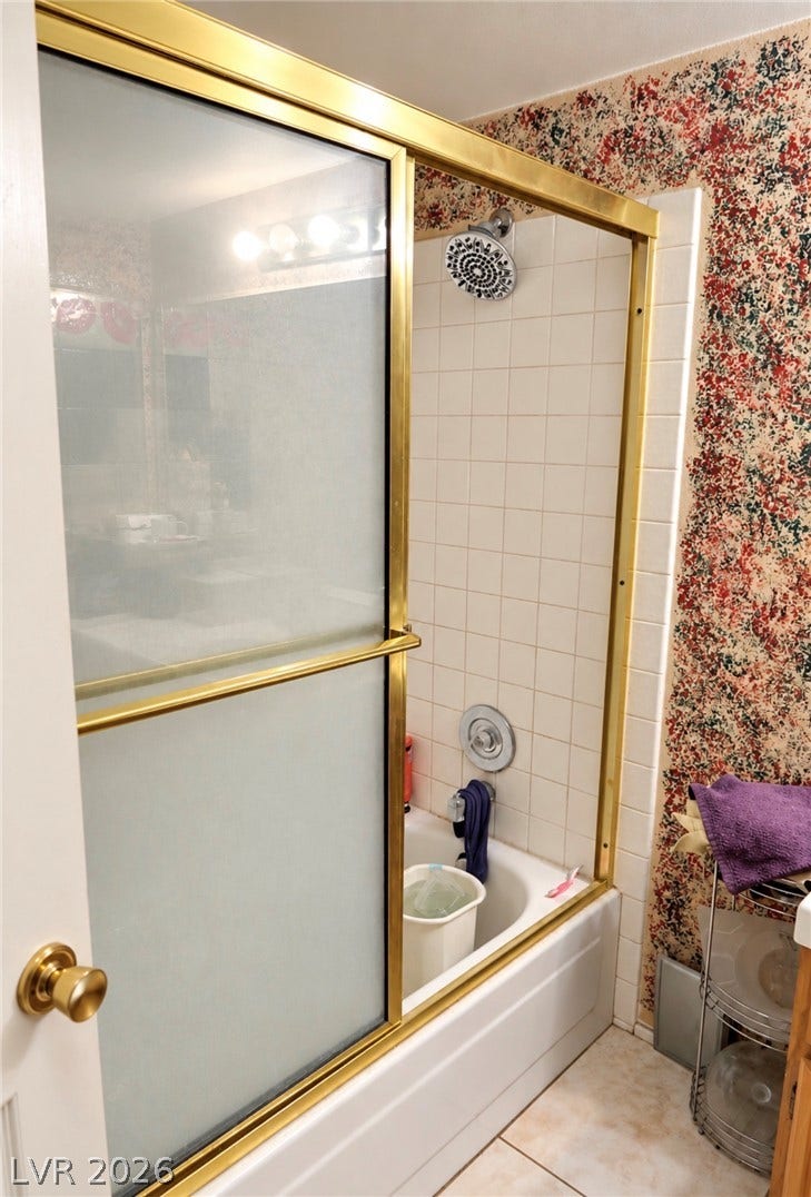 101 Luna Way, #242, Las Vegas, NV 89145 Tiled walls enclose this classic bathtub and shower combination featuring framed sliding doors.