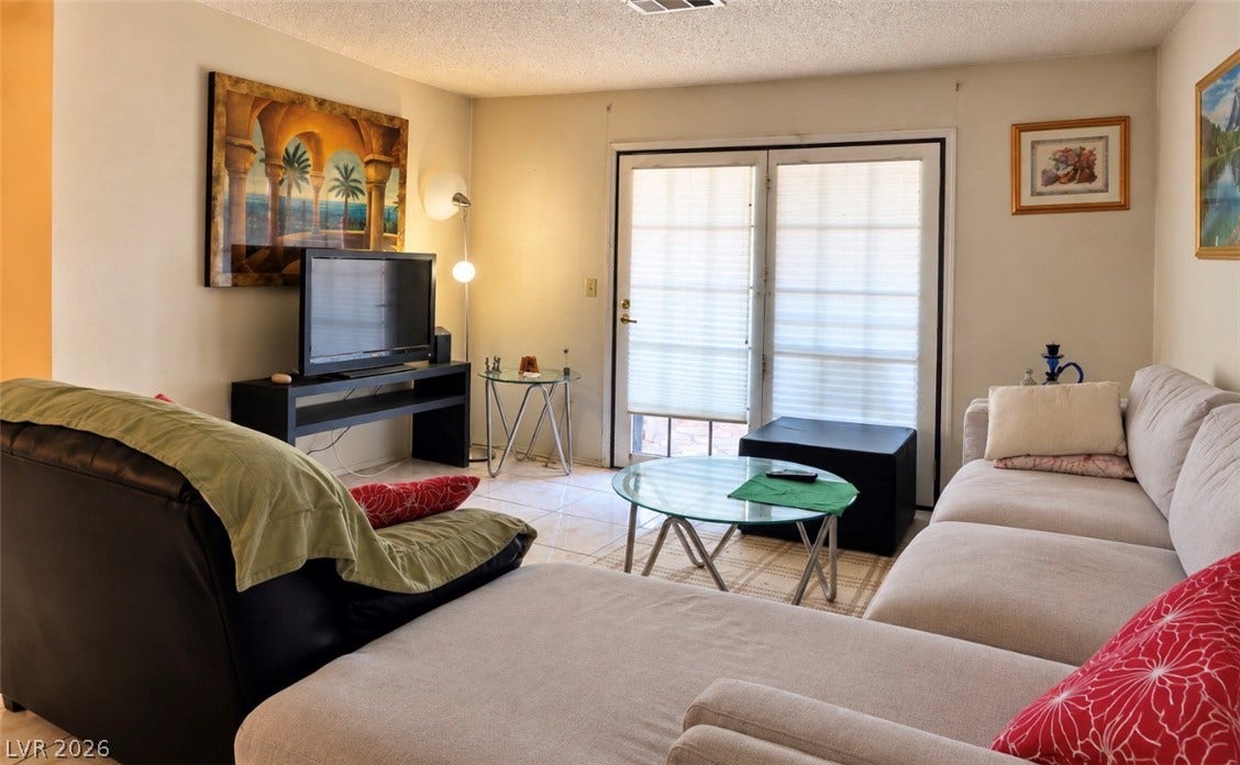 101 Luna Way, #242, Las Vegas, NV 89145 French doors open to the outdoors from this inviting tiled living space.