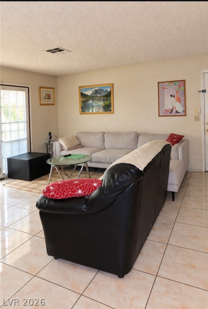 101 Luna Way, #242, Las Vegas, NV 89145 Tiled flooring and a glass-paneled door highlight this functional living space.