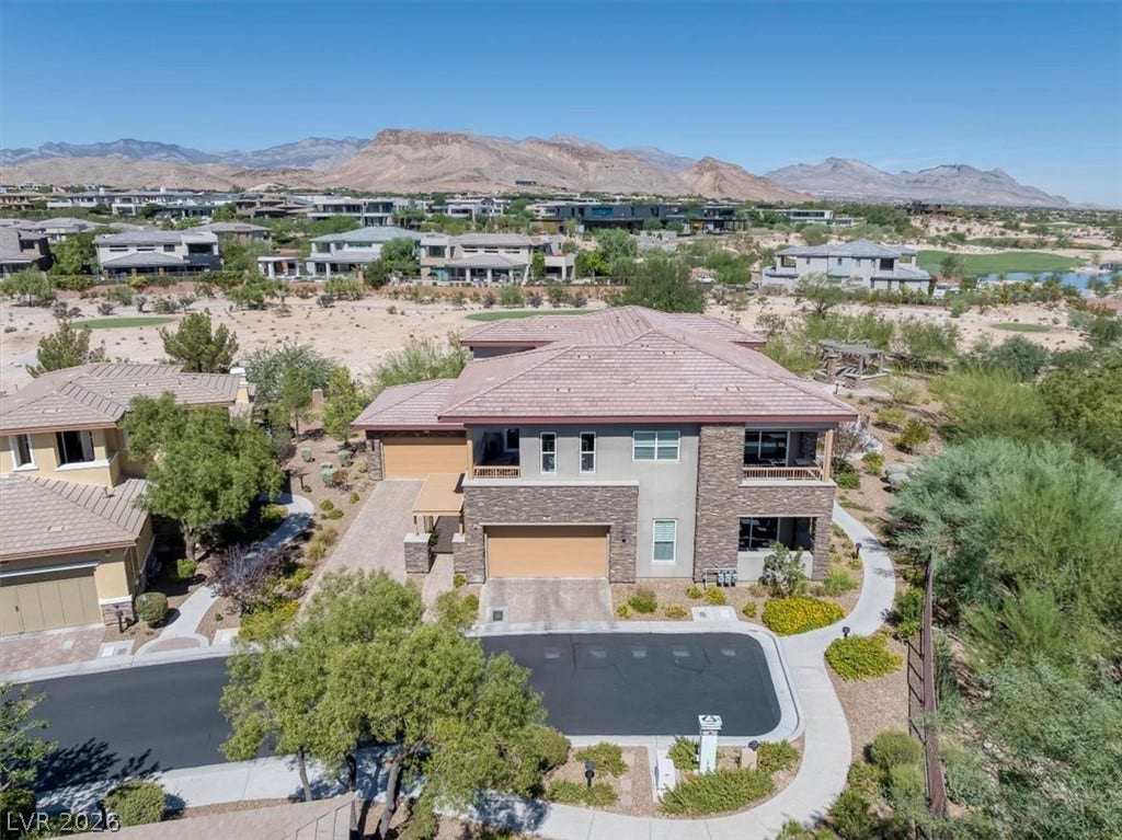 11280 Granite Ridge Drive, #1048, Las Vegas, NV 89135 Desert mountains provide a dramatic backdrop for this multi-level home featuring prominent stone accents.