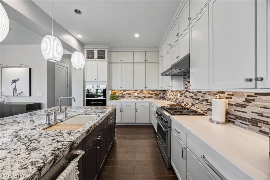 11280 Granite Ridge Drive, #1048, Las Vegas, NV 89135 Polished stone counters and extensive cabinetry define this well-appointed gourmet kitchen.