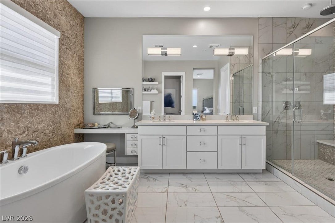 11280 Granite Ridge Drive, #1048, Las Vegas, NV 89135 A spacious master bathroom showcases a soaking tub alongside a double vanity and walk-in shower.