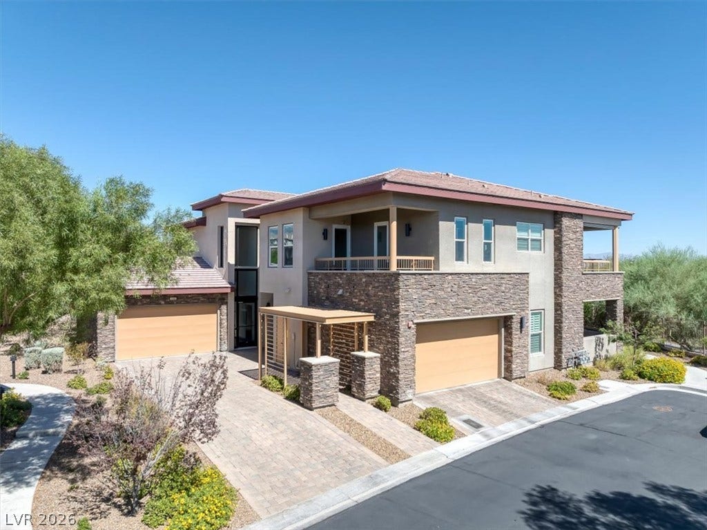 11280 Granite Ridge Drive, #1048, Las Vegas, NV 89135 Clean modern architectural lines blend stone veneer with stucco under clear blue desert skies.