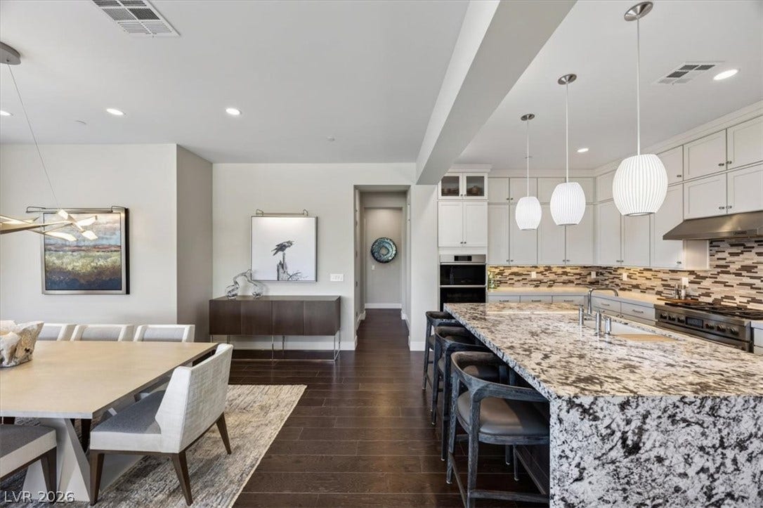11280 Granite Ridge Drive, #1048, Las Vegas, NV 89135 Granite countertops and rich wood flooring anchor this open culinary and dining space.