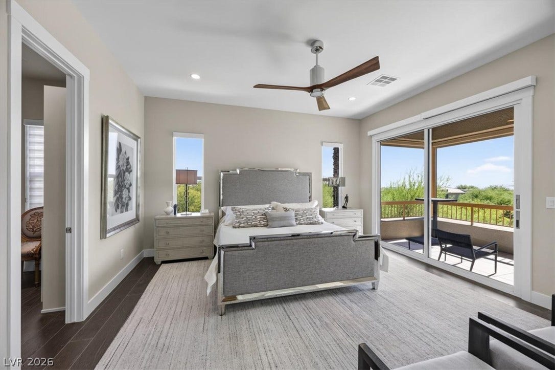 11280 Granite Ridge Drive, #1048, Las Vegas, NV 89135 Sliding glass doors open directly to a private balcony overlooking scenic green views.