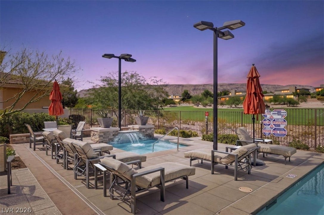 11280 Granite Ridge Drive, #1048, Las Vegas, NV 89135 A stone waterfall spa sits adjacent to the pool overlooking the golf course.