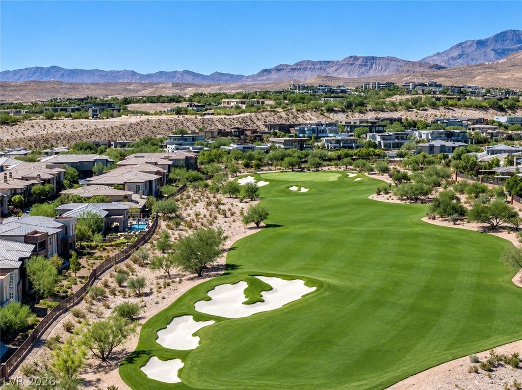 11280 Granite Ridge Drive, #1048, Las Vegas, NV 89135 A pristine golf course green stretches toward distant mountains under clear blue skies.