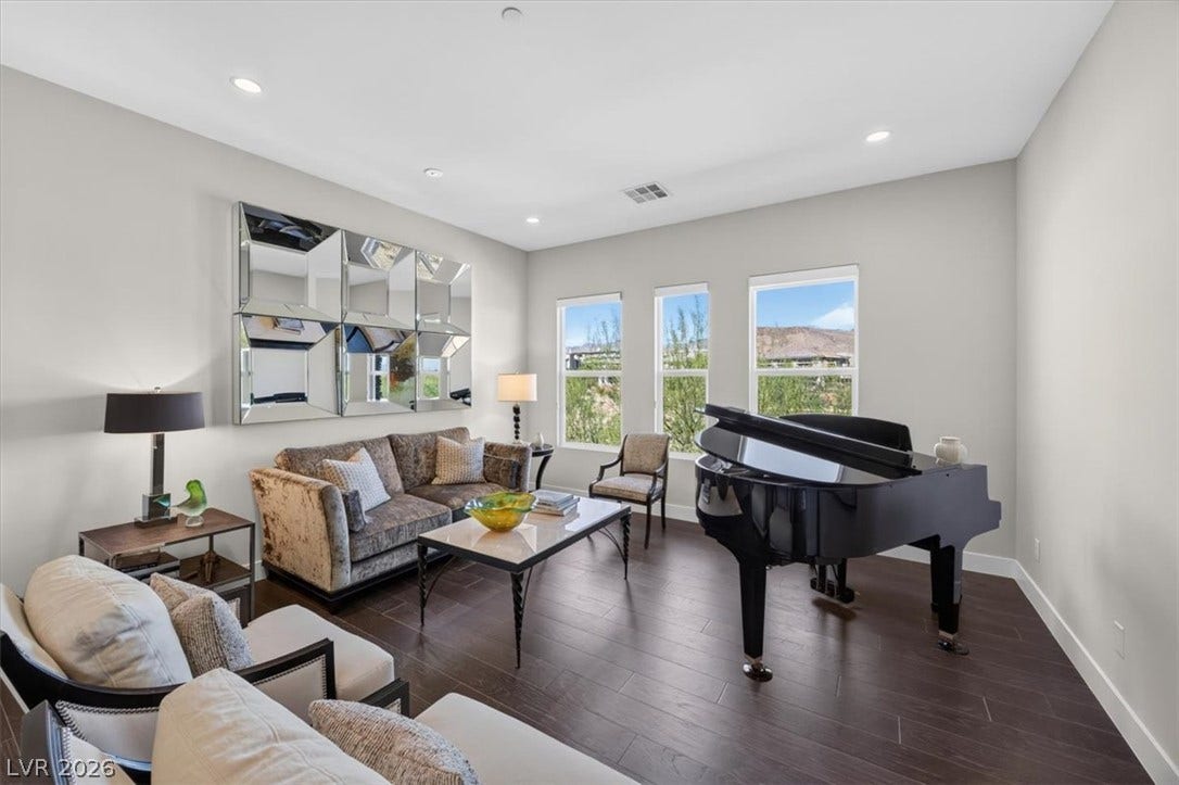 11280 Granite Ridge Drive, #1048, Las Vegas, NV 89135 Rich wood flooring anchors this inviting space, illuminated by recessed lighting and natural light.