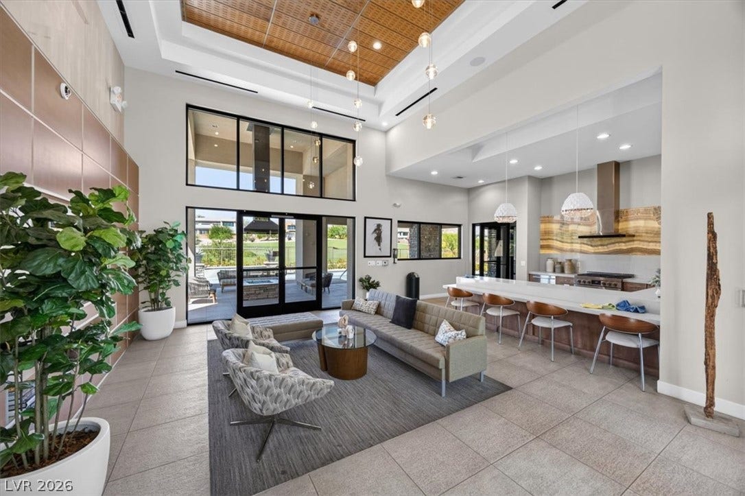 11280 Granite Ridge Drive, #1048, Las Vegas, NV 89135 Soaring ceilings and expansive glass doors anchor this airy open-concept living space.